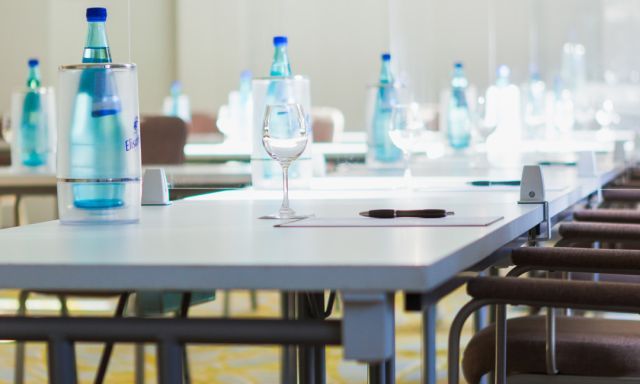 Meeting room on the ground floor Carpeted flooring Daylight U-shaped seating Water bottles, cooler Glasses