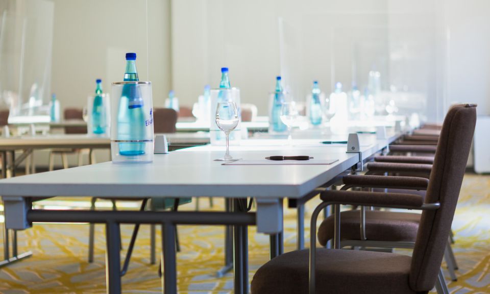 Meeting room on the ground floor Carpeted flooring Daylight U-shaped seating Water bottles, cooler Glasses