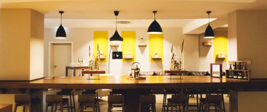 A view of the wine bar at the Weinhotel Kaisergarten, cosily lit by several ceiling lights