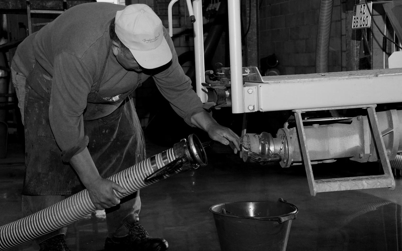 Photo in black and white the winemaker checks the mash