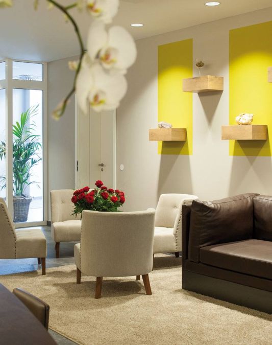 Lobby in the wine hotel Kaisergarten with designer furniture 3 chairs a large sofa in the background left the door of the hotel entrance