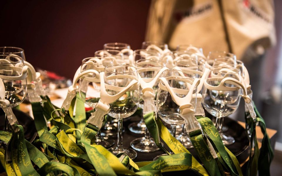 Preparations for the wine tasting a tray with empty wine glasses and straps with holders to hang around the wine glass