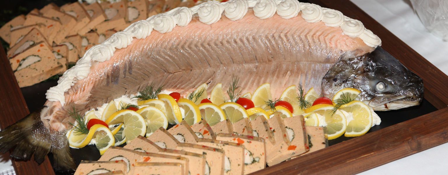 Cold-warm buffet in connection with an event at the Weinhotel Kaisergarten Alzey here a platter with smoked salmon one half portioned pieces the other half as whole salmon with garnish